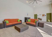 Thumbnail 21 of 42 - a living room with couches and chairs and a table