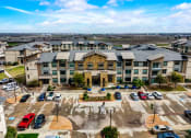 Thumbnail 33 of 33 - an aerial view of a building with cars parked in front of it