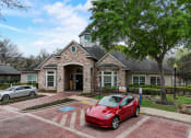 Thumbnail 35 of 42 - a red car parked in front of a house