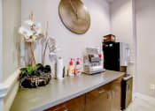 Thumbnail 26 of 42 - a kitchenette with a coffee machine refrigerator and sink