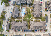 Thumbnail 30 of 35 - an aerial view of a neighborhood with houses and a swimming pool