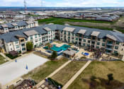 Thumbnail 27 of 33 - an aerial view of an apartment building with a swimming pool