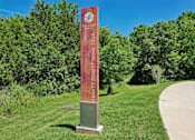 Thumbnail 42 of 55 - A signpost for the Honey Creek Trail stands in a grassy area.