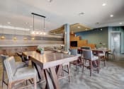 Thumbnail 23 of 50 - a large dining room with tables and chairs and a kitchen