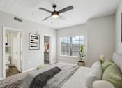 Thumbnail 29 of 70 - A bedroom with a bed, a ceiling fan, and a window with blinds.