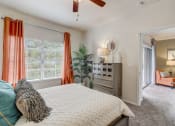 Thumbnail 9 of 44 - a bedroom with a large bed and a ceiling fan
