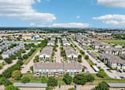Thumbnail 30 of 32 - A bird's eye view of a residential area with houses and apartment buildings.