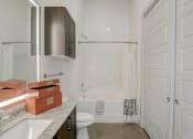 Thumbnail 15 of 37 - a white bathroom with a shower and a sink and a toilet