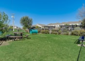 Thumbnail 33 of 42 - a backyard with a picnic table and a playground