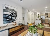 Thumbnail 19 of 31 - A modern kitchen with a large painting on the wall.