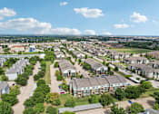 Thumbnail 31 of 32 - A bird's eye view of a residential area with houses and trees.
