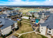 Thumbnail 28 of 33 - an aerial view of a community with houses and a pool