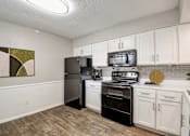 Thumbnail 11 of 42 - a kitchen with white cabinets and stainless steel appliances