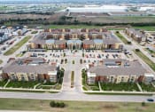 Thumbnail 41 of 44 - an aerial view of an apartment complex in a parking lot