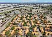 Thumbnail 43 of 45 - A suburban neighborhood with houses and a large building in the background.