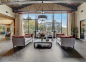Thumbnail 15 of 50 - a large living room with couches and chairs and large windows