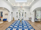Thumbnail 14 of 27 - A large blue and white rug is on the floor of a spacious room.