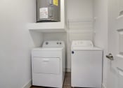 Thumbnail 22 of 44 - a small laundry room with a washer and dryer in it and a door
