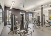 Thumbnail 25 of 37 - a gym with weights and cardio equipment at the district flats apartments