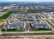 Thumbnail 31 of 33 - an aerial view of a group of buildings and an airport