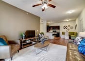 Thumbnail 2 of 42 - a living room with a ceiling fan and hardwood flooring