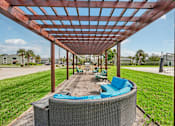 Thumbnail 23 of 33 - A patio with a hot tub and a pergola.