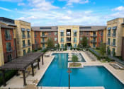 Thumbnail 34 of 44 - an aerial view of an apartment complex with a large pool