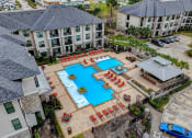 Thumbnail 46 of 52 - an aerial view of an apartment complex with a large swimming pool