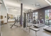 Thumbnail 28 of 37 - a gym with weights and other exercise equipment and windows