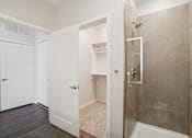 Thumbnail 19 of 55 - A bathroom with a stand-up shower and walk-in closet.