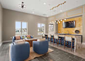 Thumbnail 22 of 29 - A modern living room with a bar area and a television.