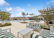 Thumbnail 14 of 29 - A sunny day at the poolside with green and white striped sun loungers.