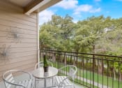 Thumbnail 18 of 44 - a patio with a table and chairs on a balcony