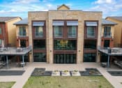 Thumbnail 36 of 44 - an exterior view of a brick building with balconies and a courtyard