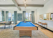Thumbnail 22 of 43 - A room with a pool table and a bar area.