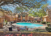 Thumbnail 39 of 45 - A pool surrounded by trees and chairs.