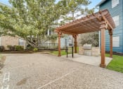 Thumbnail 12 of 27 - a patio with a pergola in front of a house