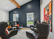 Thumbnail 45 of 79 - A room with black walls and a large painting on the wall.