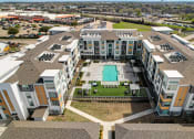Thumbnail 38 of 44 - an aerial view of a building with a pool in the middle