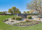 Thumbnail 41 of 42 - a park with flowers and a sign in the grass