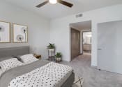 Thumbnail 6 of 44 - a bedroom with a bed and a ceiling fan