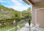 Thumbnail 19 of 44 - a patio with a table and chairs on a balcony