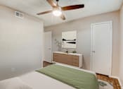 Thumbnail 17 of 42 - a bedroom with a bed and a ceiling fan