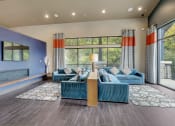 Thumbnail 19 of 50 - a living room with blue couches and a large window