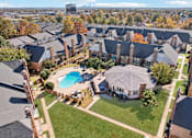 Thumbnail 29 of 35 - A bird's eye view of a residential area with houses and a swimming pool.