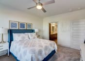 Thumbnail 20 of 44 - a bedroom with a large bed and a ceiling fan