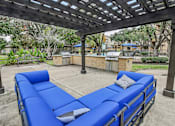 Thumbnail 22 of 27 - A blue lounge chair under a wooden pergola.