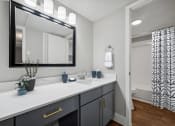 Thumbnail 8 of 41 - a bathroom with a large mirror and a sink and a toilet