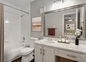 Thumbnail 13 of 42 - a bathroom with a white sink and toilet next to a white bathtub