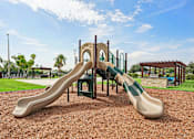 Thumbnail 26 of 33 - A playground with a green and tan slide.